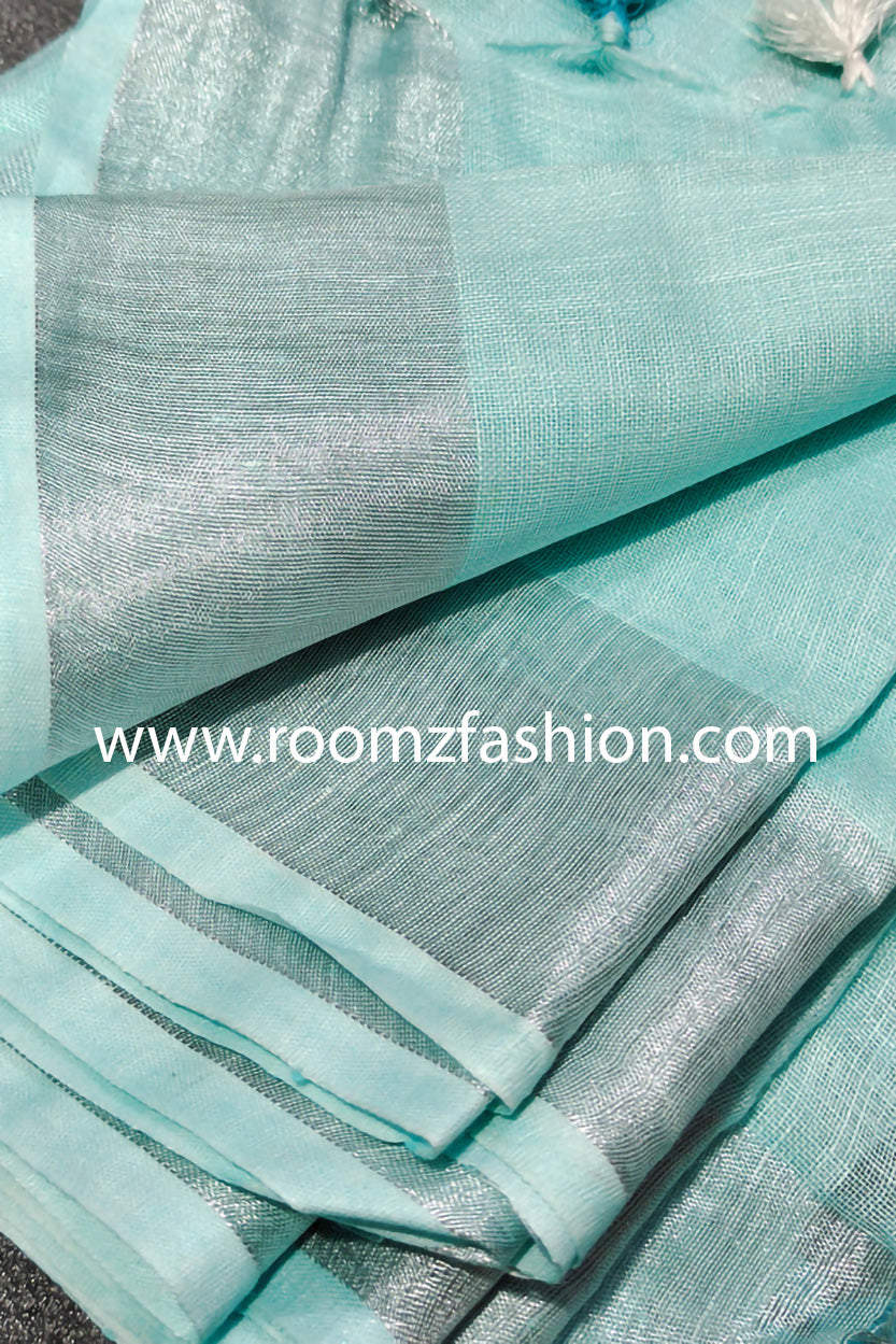 Turquoise linen saree with silver border draped elegantly