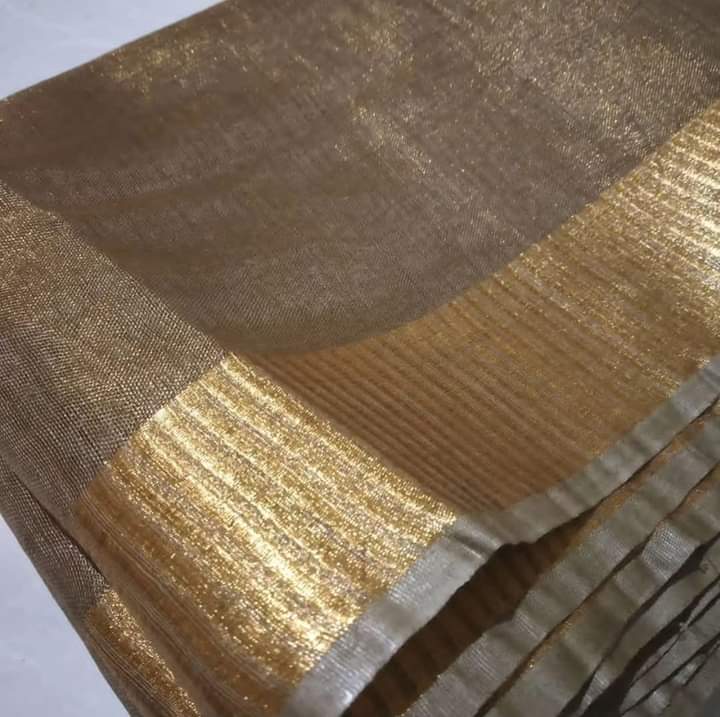 Khaki tissue linen saree with golden zari border draped elegantly