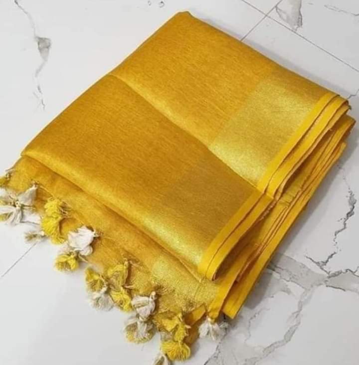 Gold tissue saree with golden zari border draped elegantly