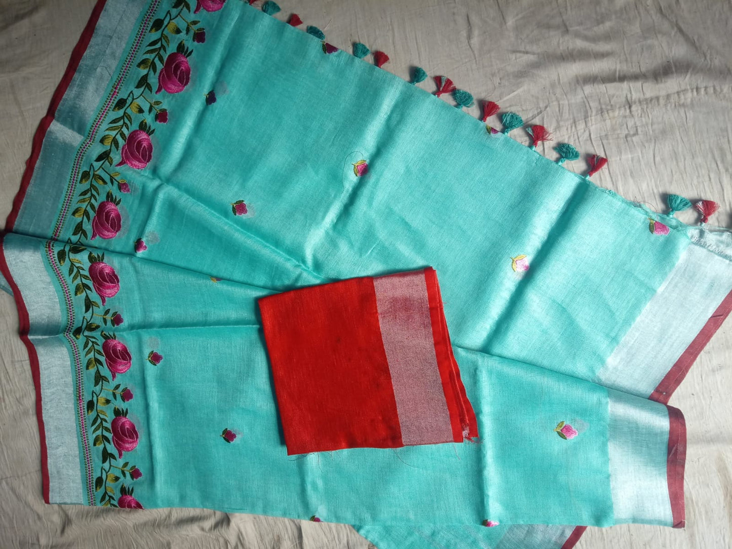 Close-up of silver zari waving pallu with floral embroidery