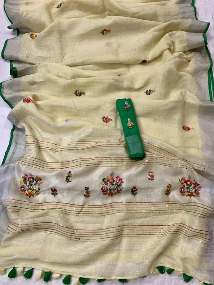 Off-white linen saree with silver border and green piping draped elegantly