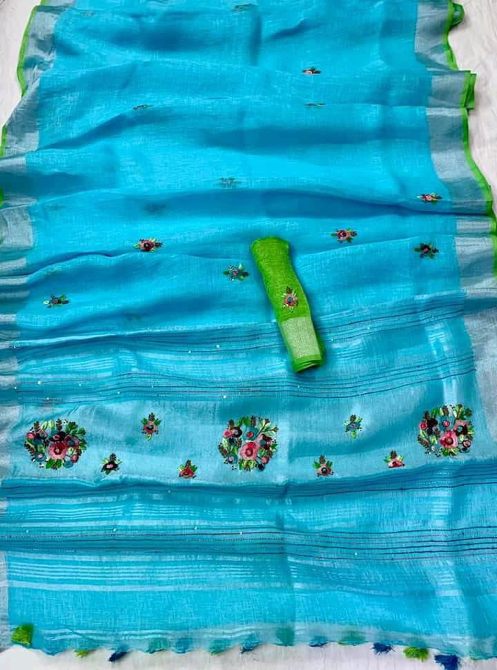 Firoza (turquoise) linen saree with silver border and green piping draped elegantly