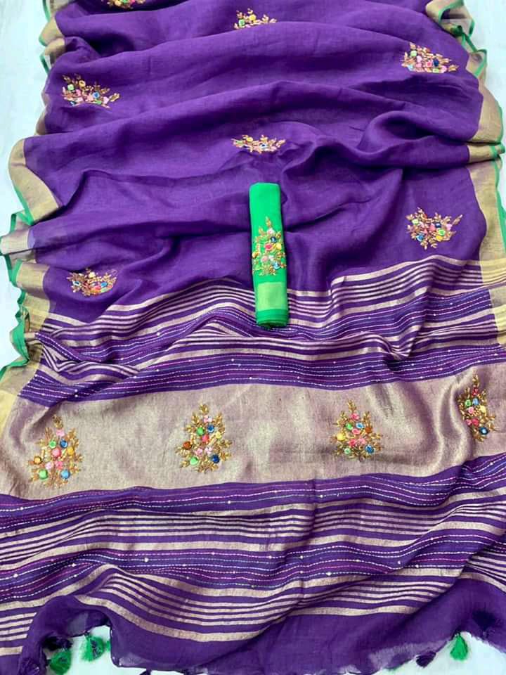 Purple linen saree with golden border and green piping draped elegantly