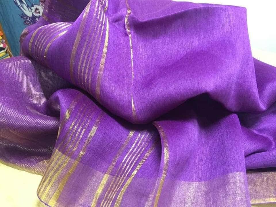 Royal purple silk linen saree with golden zari border draped elegantly