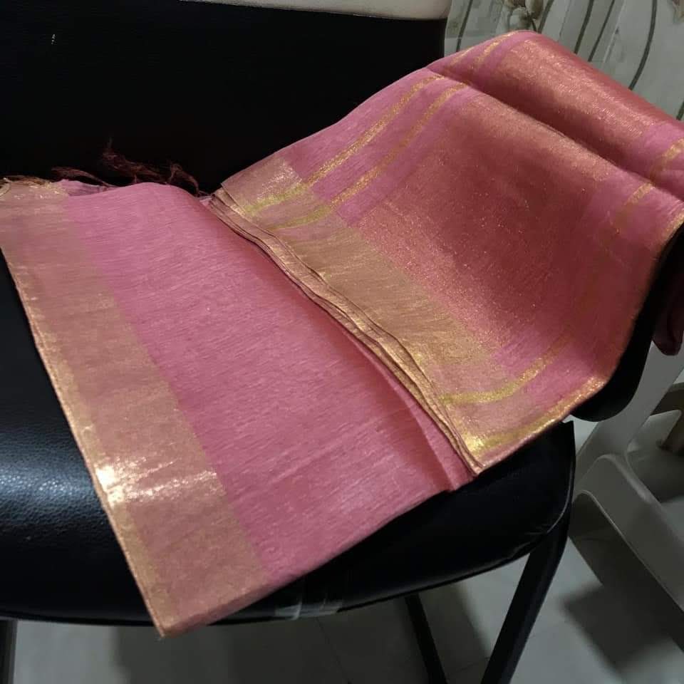 "Elegant pink silk linen saree with golden zari borders draped on model"