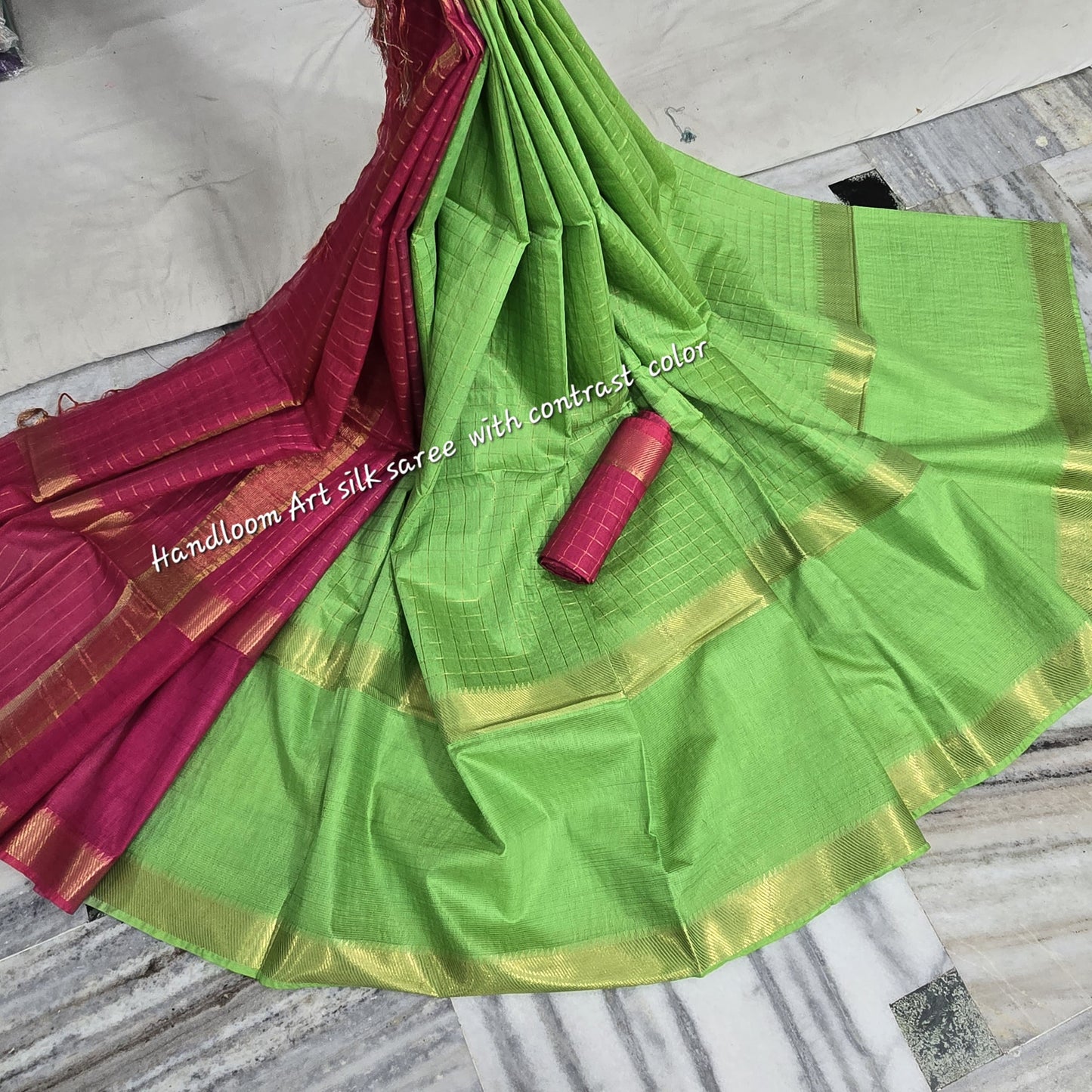 Green-red dual-tone silk saree with golden border draped elegantly