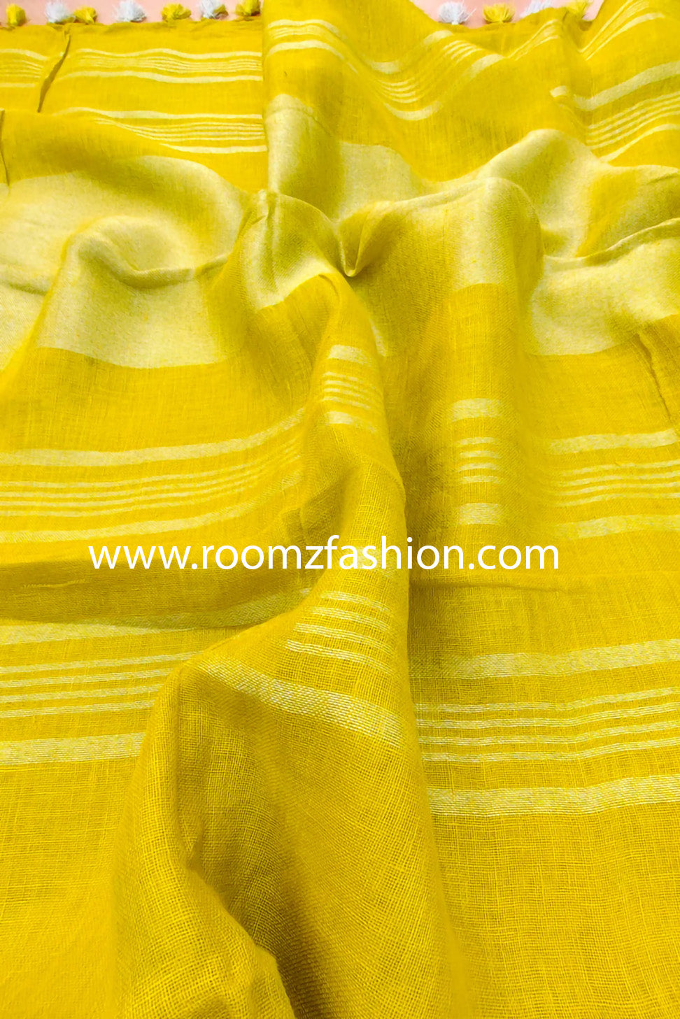 Yellow linen saree with silver zari border draped elegantly