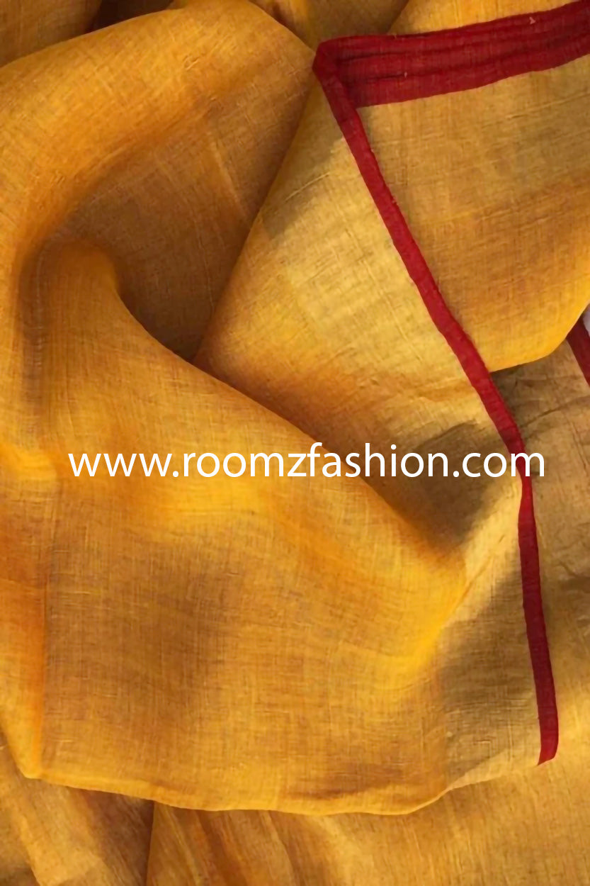 Mango linen saree with golden border and red piping draped elegantly