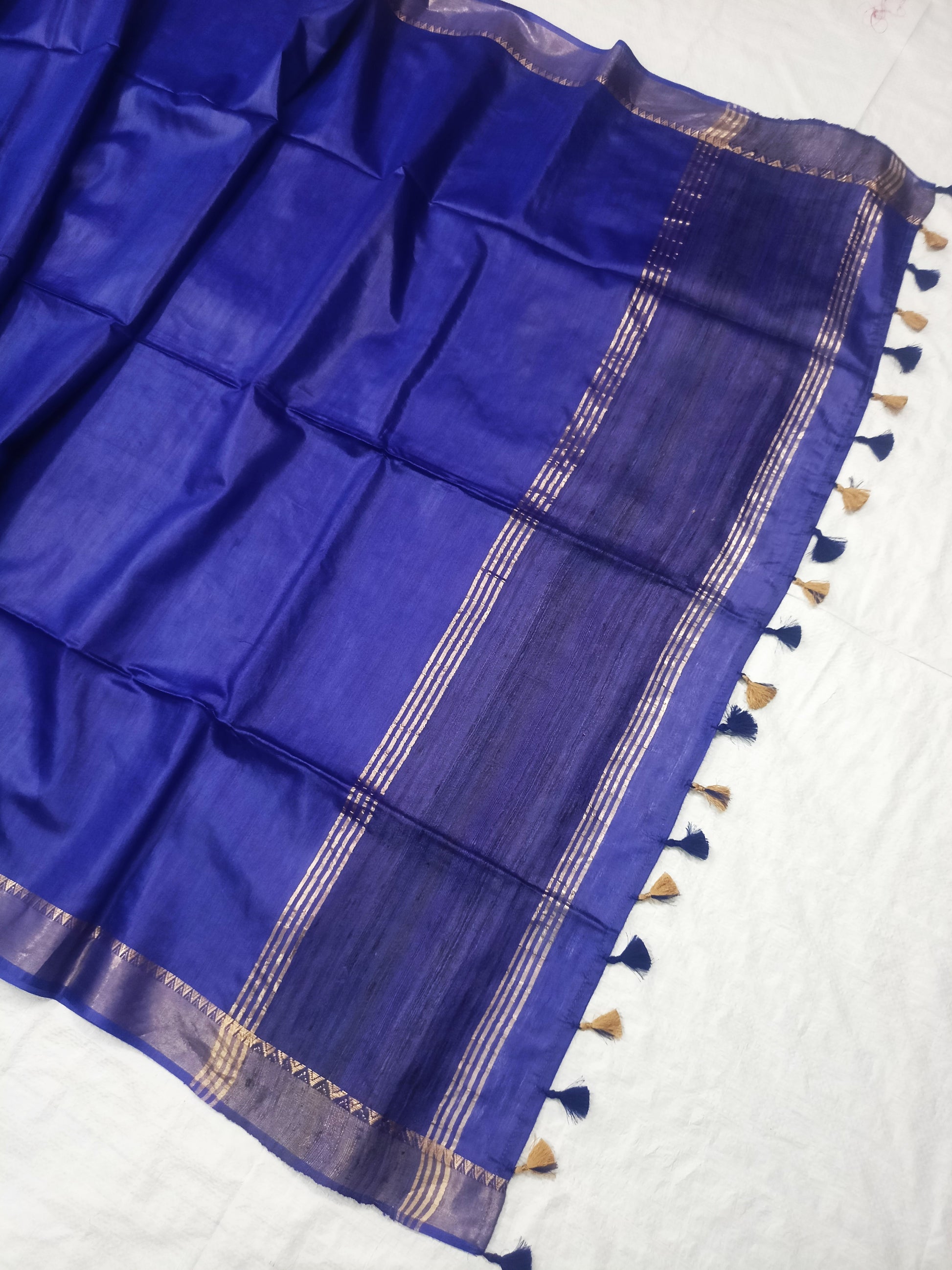 Blue silk saree draped showing golden border details