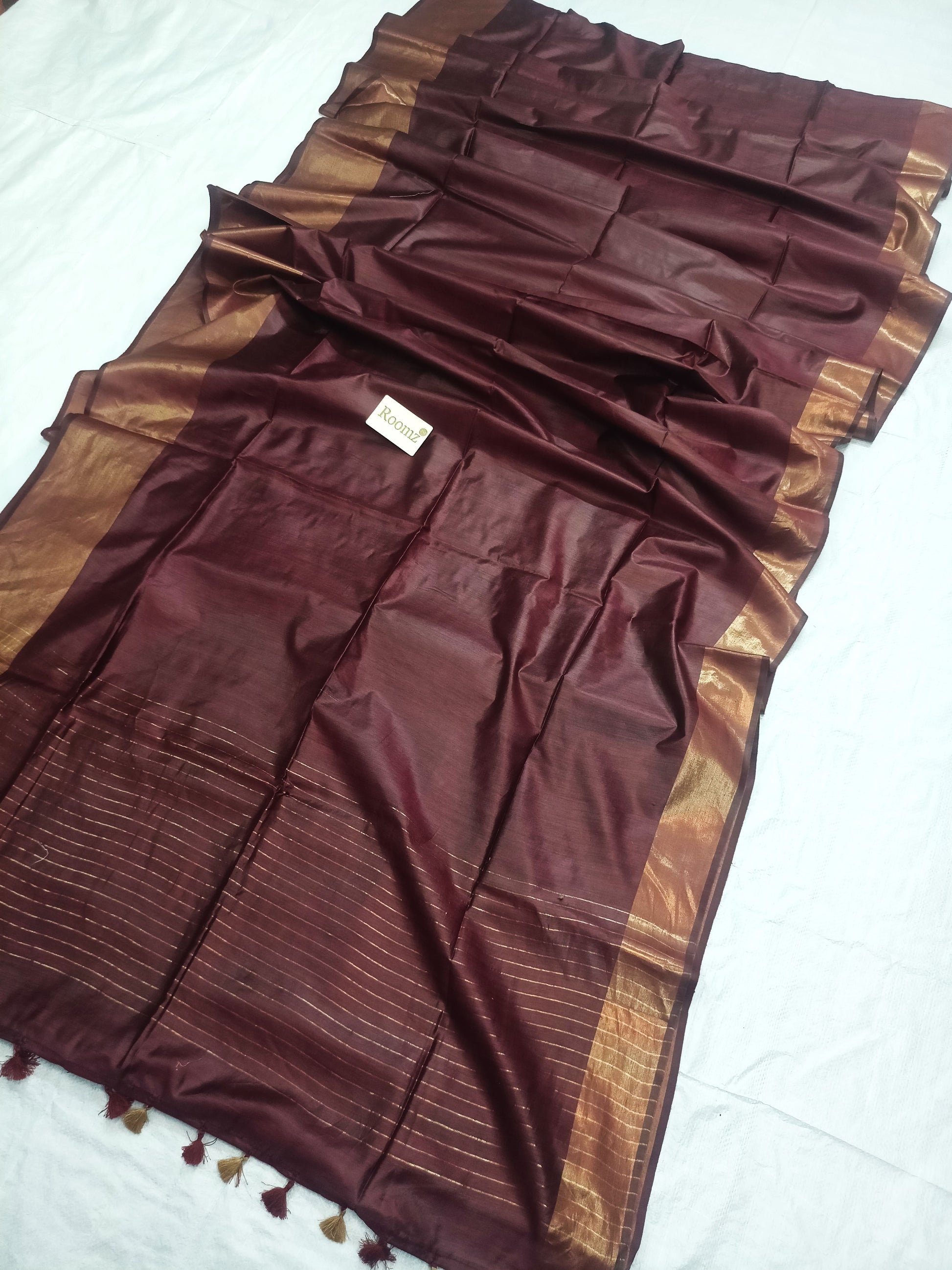 Close-up of Tussar Munga silk texture on brown saree - Roomz Fashion