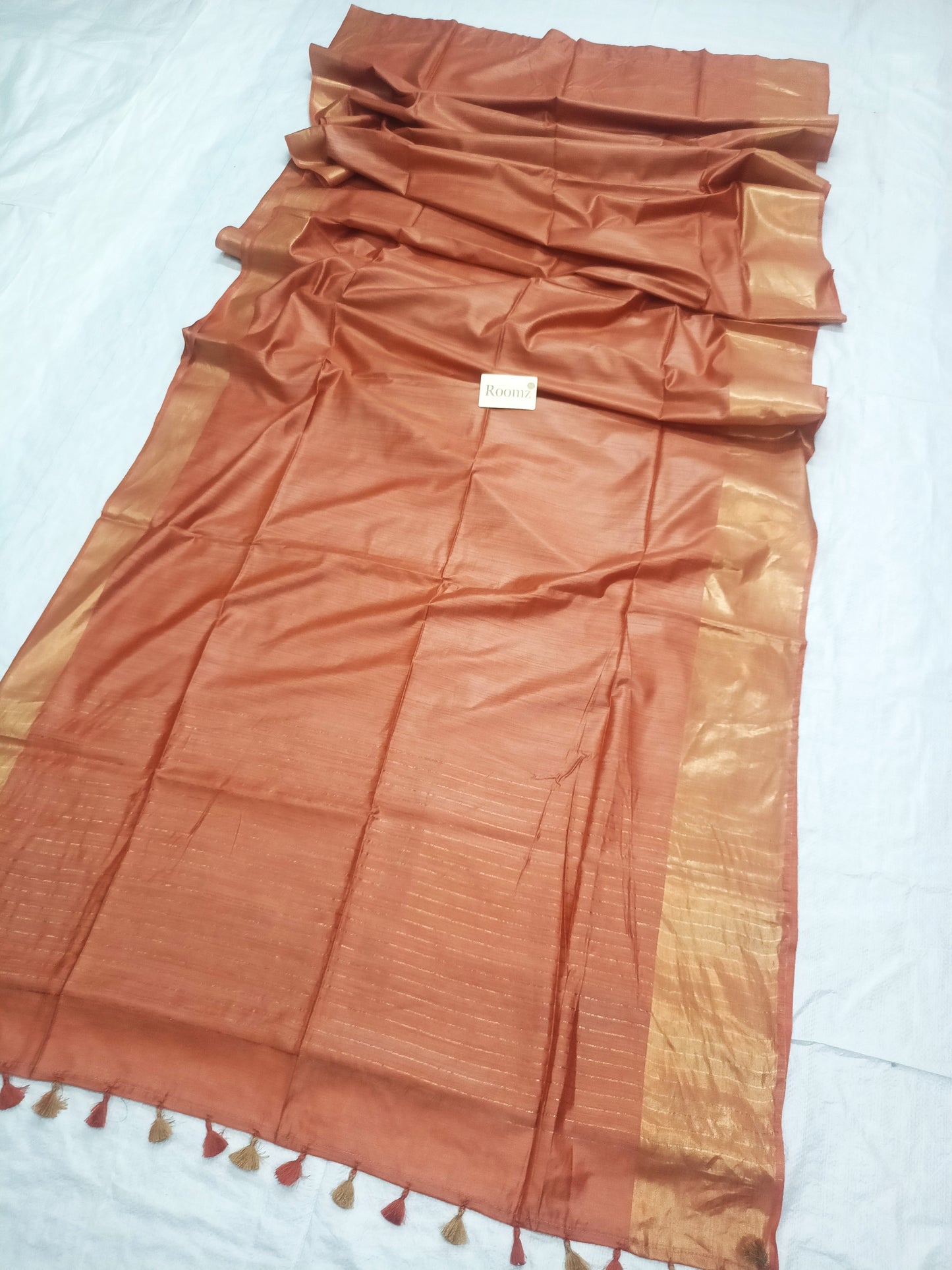 Close-up of Tussar Munga silk texture on peach saree - Roomz Fashion