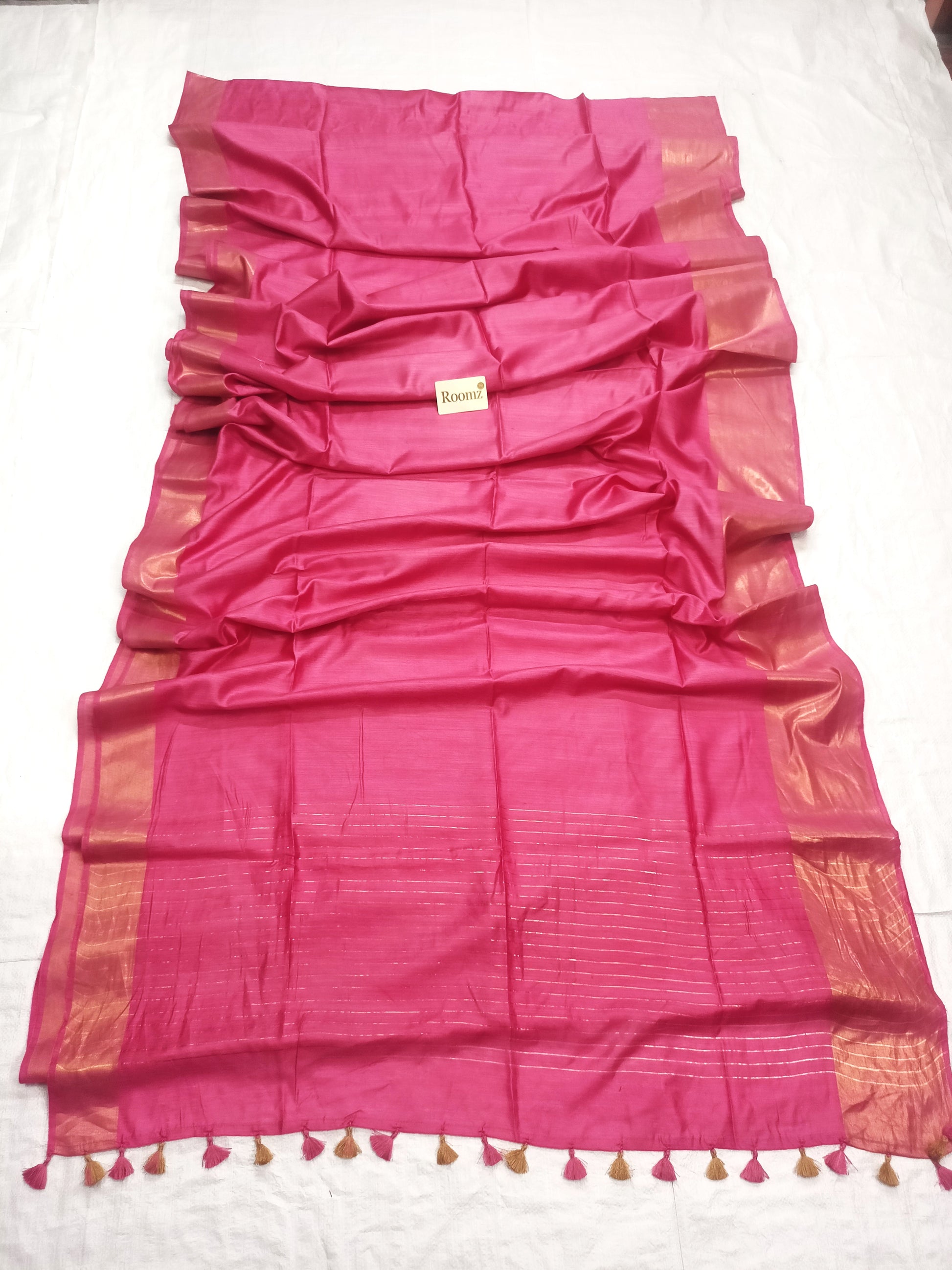 Close-up of Tussar Munga silk texture on pink saree