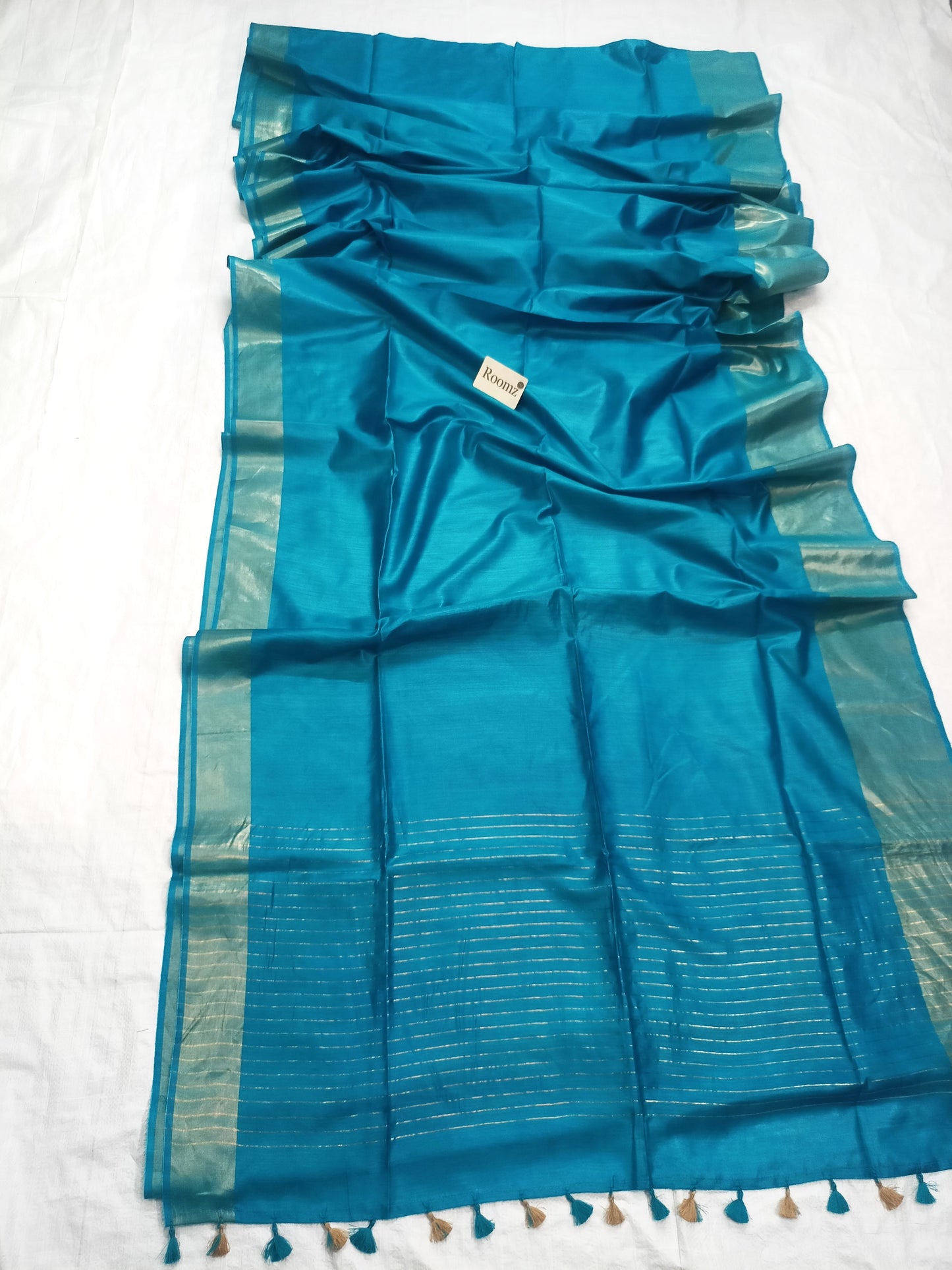 Close-up of Tussar Munga silk texture on turquoise saree