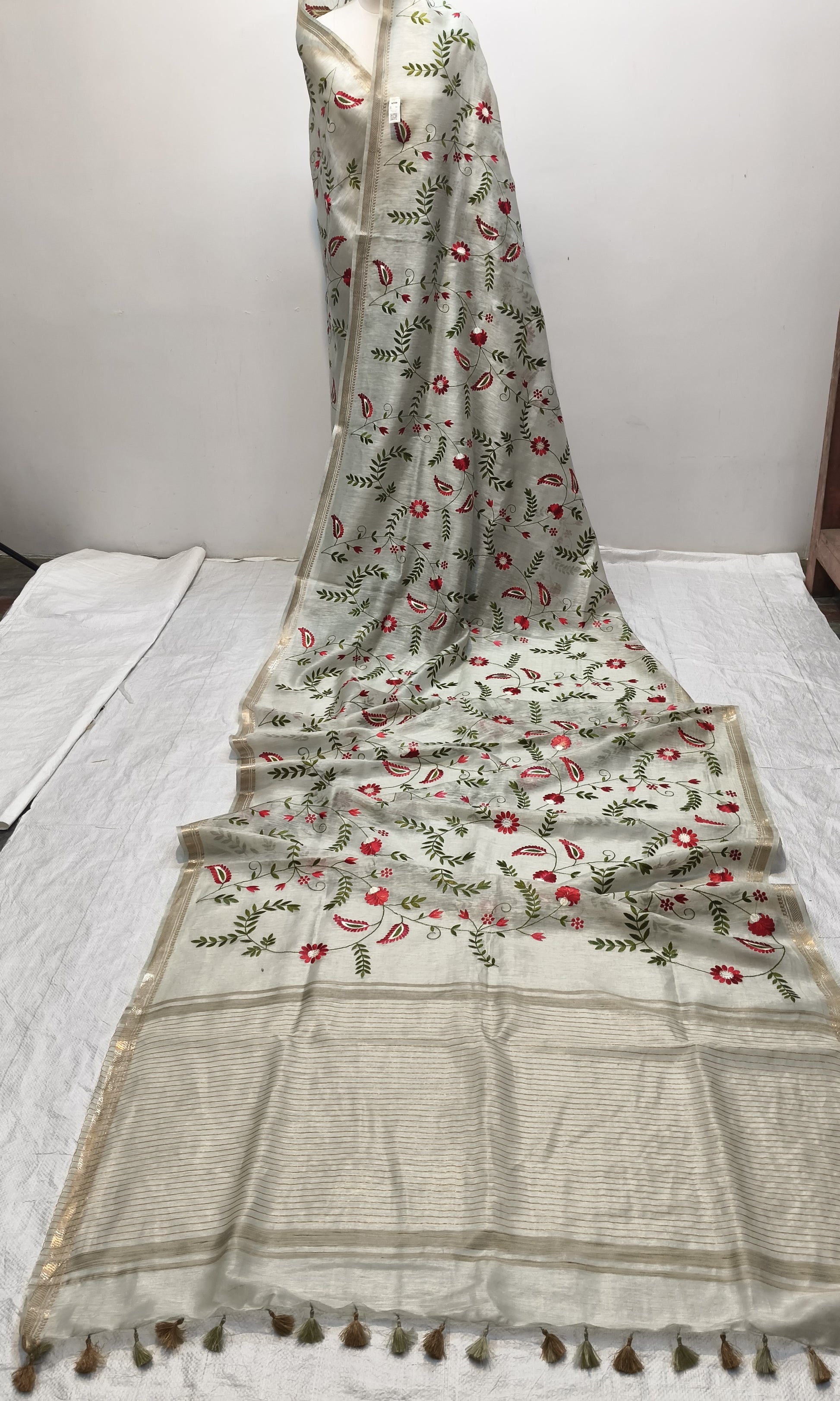 Close-up of embroidery detail on light green silk linen saree - Roomz Fashion