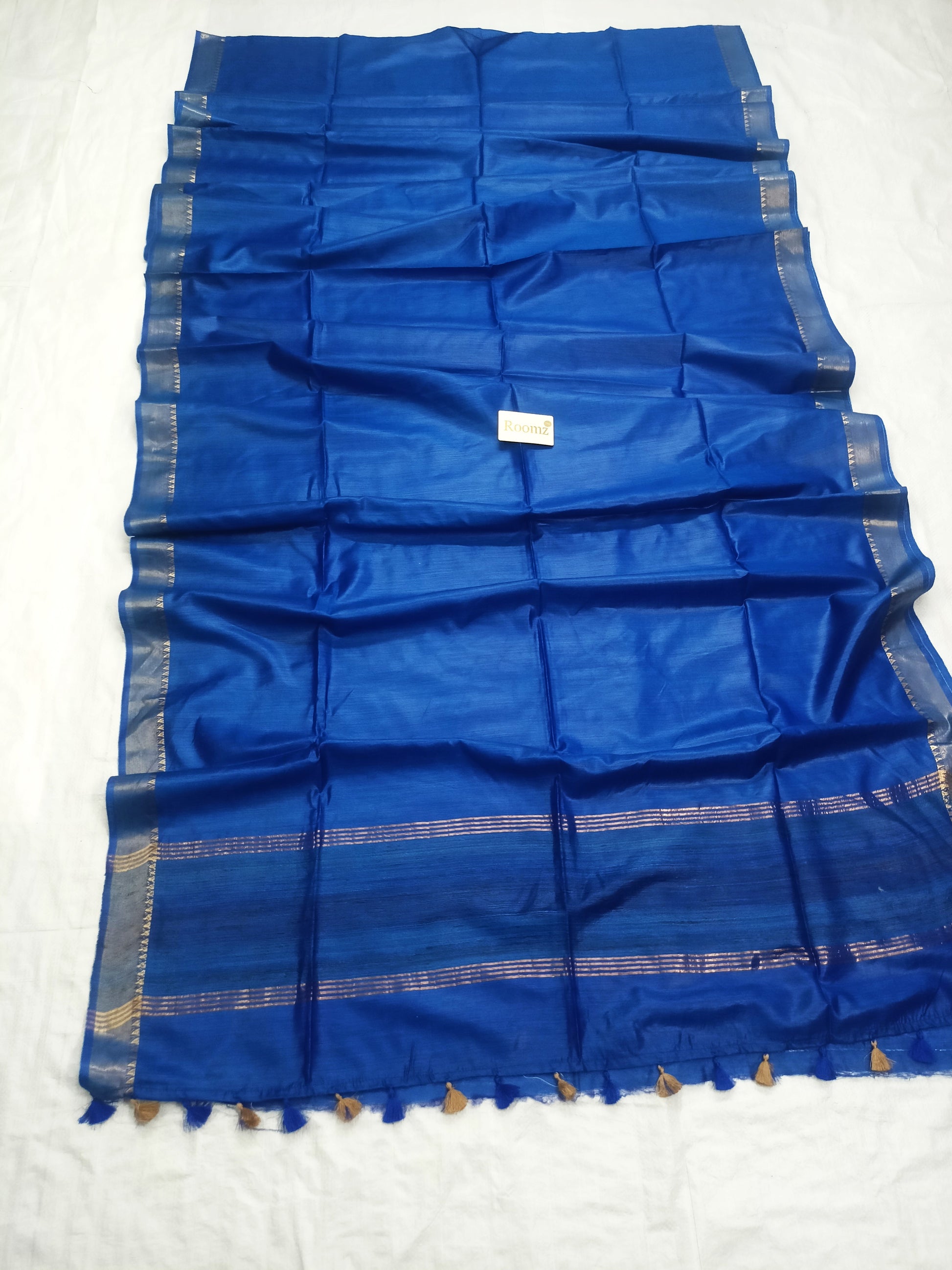 Close-up of golden zari work on royal blue Tussar saree - Roomz