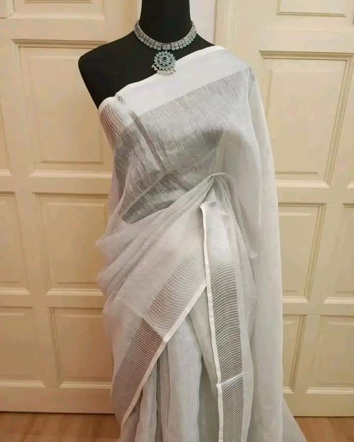 Silver tissue linen saree with zari border draped elegantly