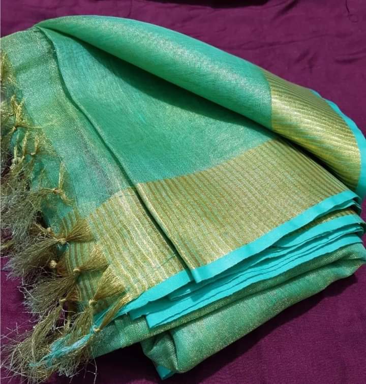 Green tissue saree with golden zari border draped elegantly