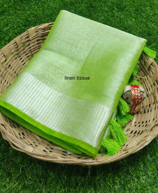 Green tissue linen saree with silver zari border draped elegantly