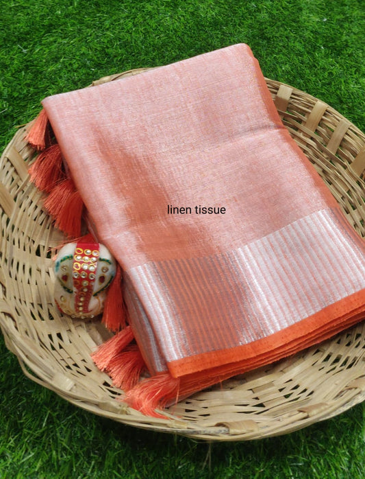 Orange tissue linen saree with silver zari border draped elegantly