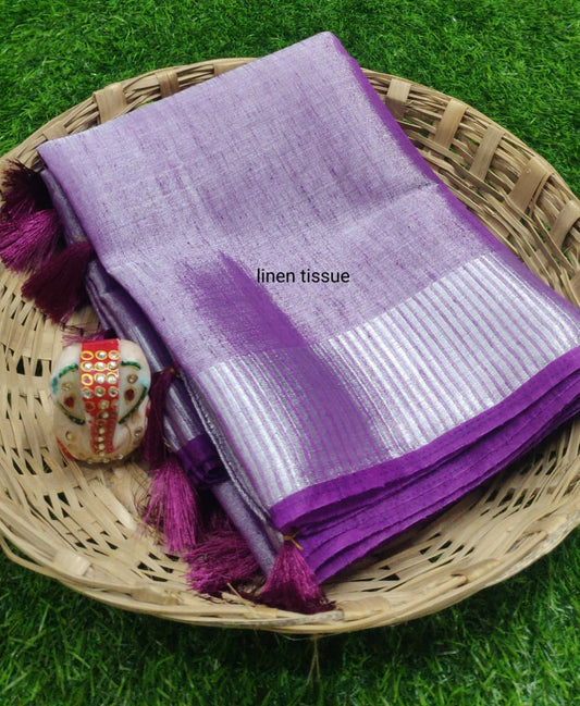 Purple tissue linen saree with silver zari border draped elegantly