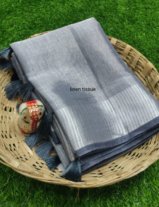 Gray tissue linen saree with silver zari border draped elegantly
