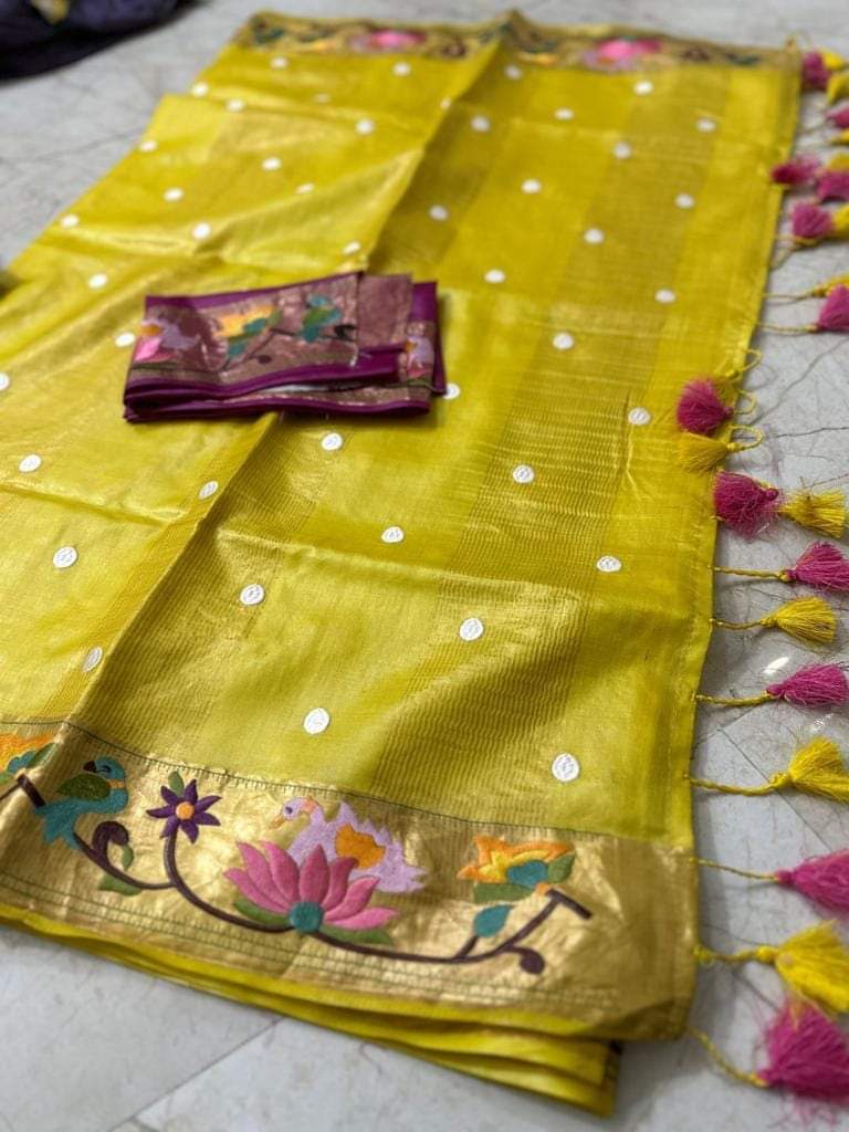 Close-up of golden zari border on yellow saree