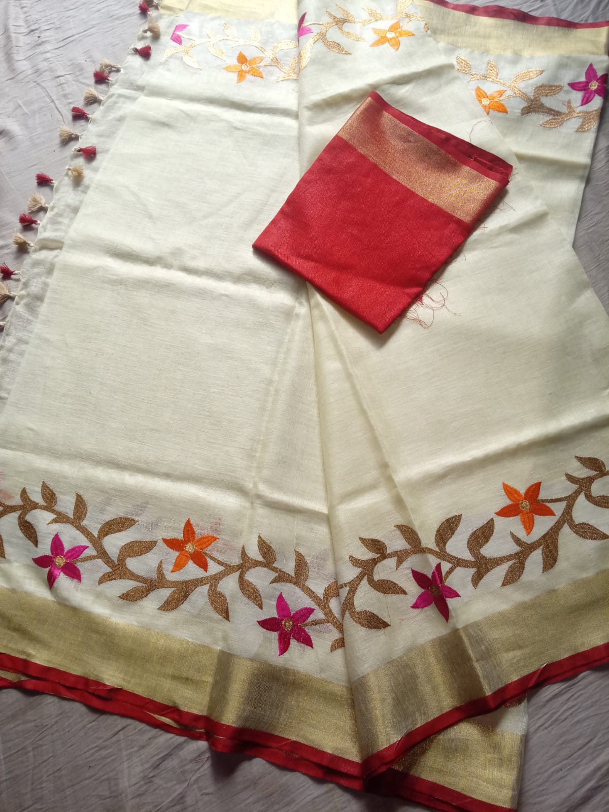Close-up of golden zari waving pallu with floral embroidery