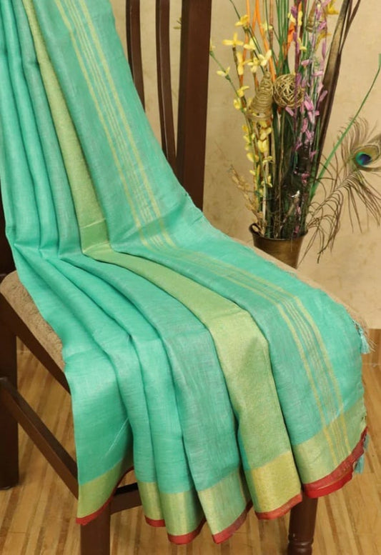 Green linen saree with golden zari border and red piping - Roomz Festive Collection