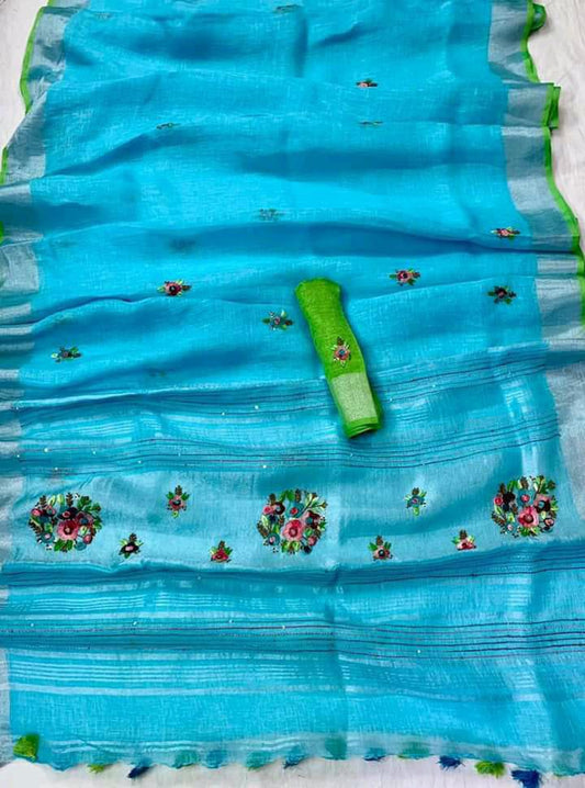Firoza (turquoise) linen saree with silver border and green piping draped elegantly