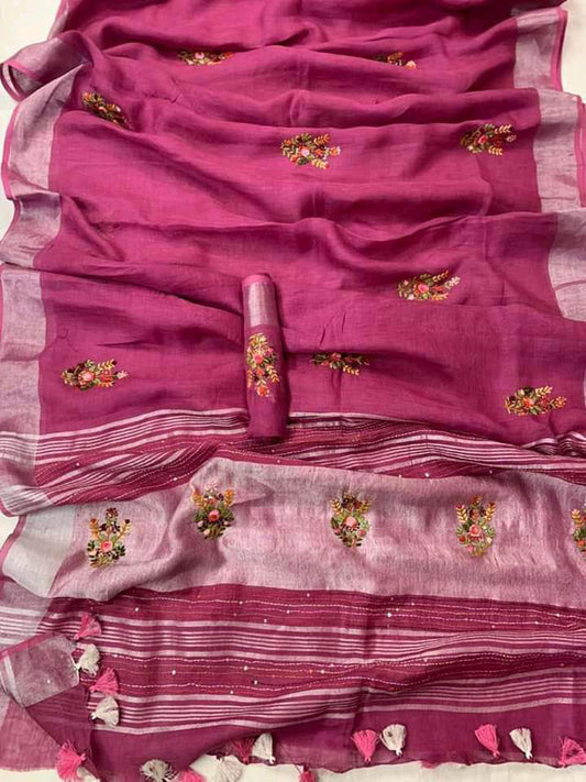 Reddish-pink linen saree with silver zari border draped elegantly