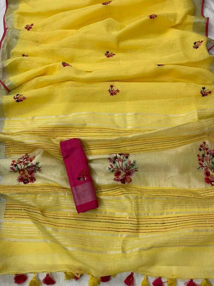 Peach linen saree with silver-zari border and hand embroidery draped elegantly