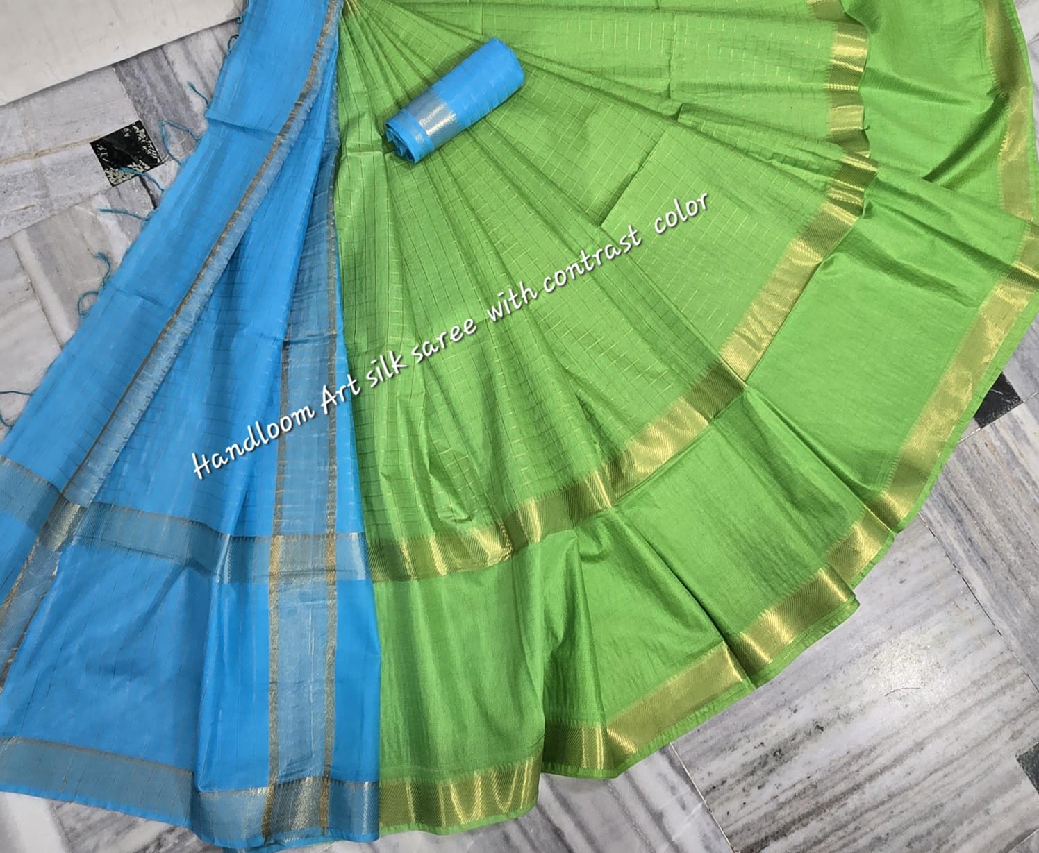 Green-turquoise dual-tone silk saree with golden border draped elegantly