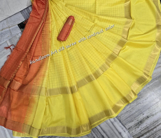 Yellow-orange dual-tone silk saree with golden border draped elegantly