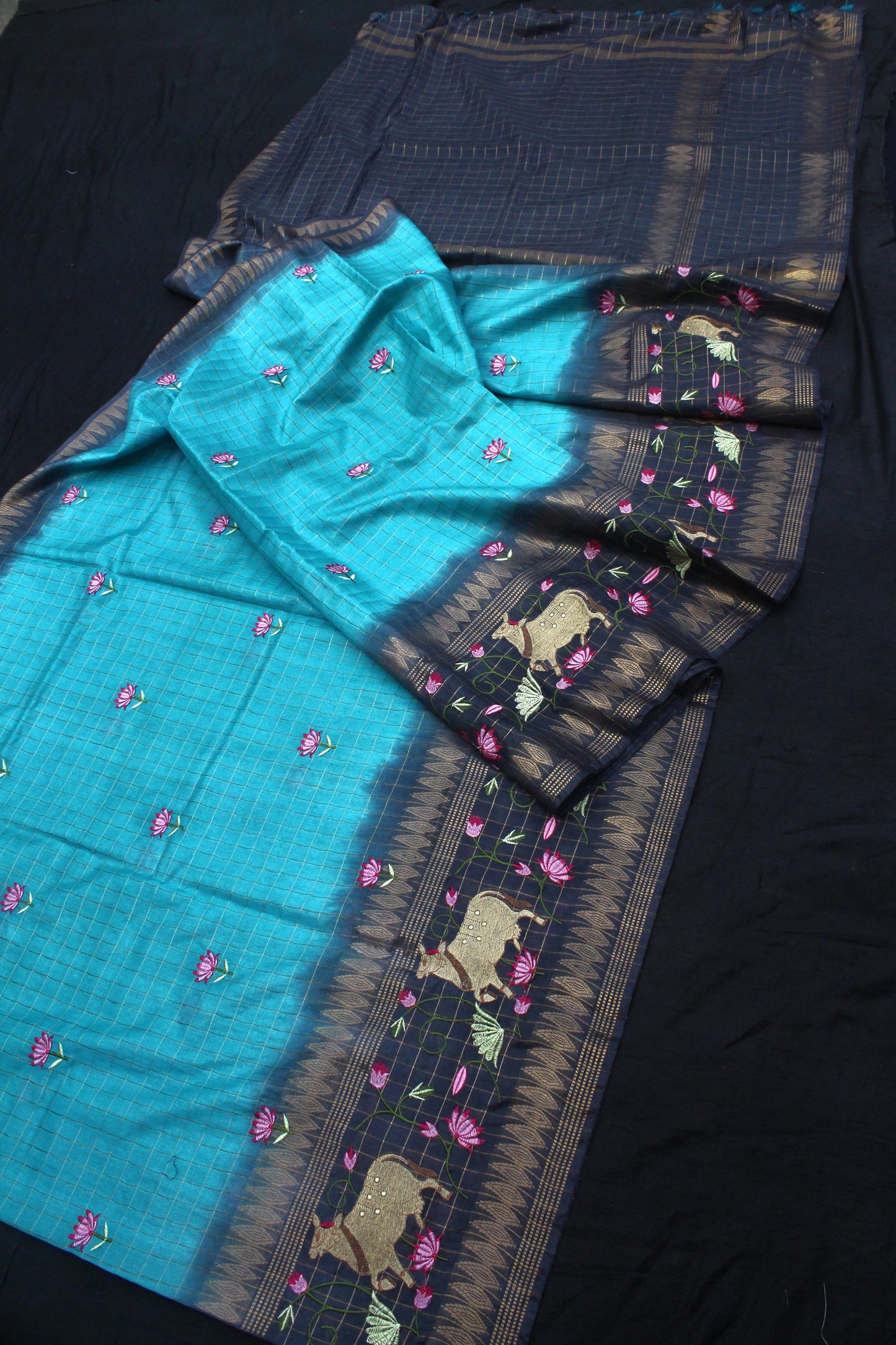 Close-up of turquoise-gray transition with embroidery