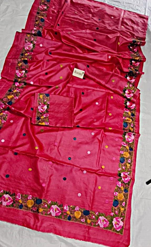 Close-up of floral embroidery and polka dots on pink Tussar silk