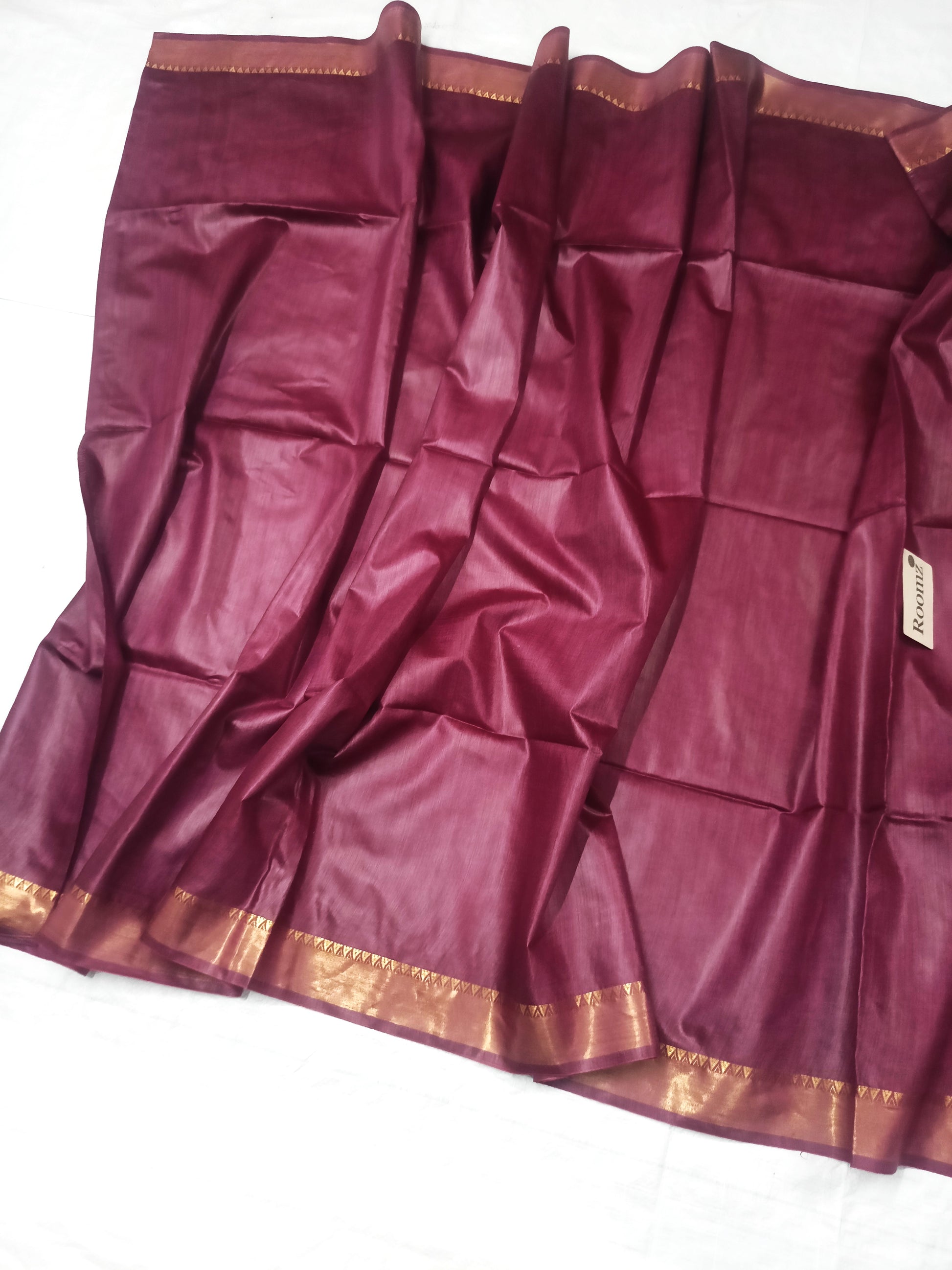 Draped brown Tussar silk saree showing the golden border