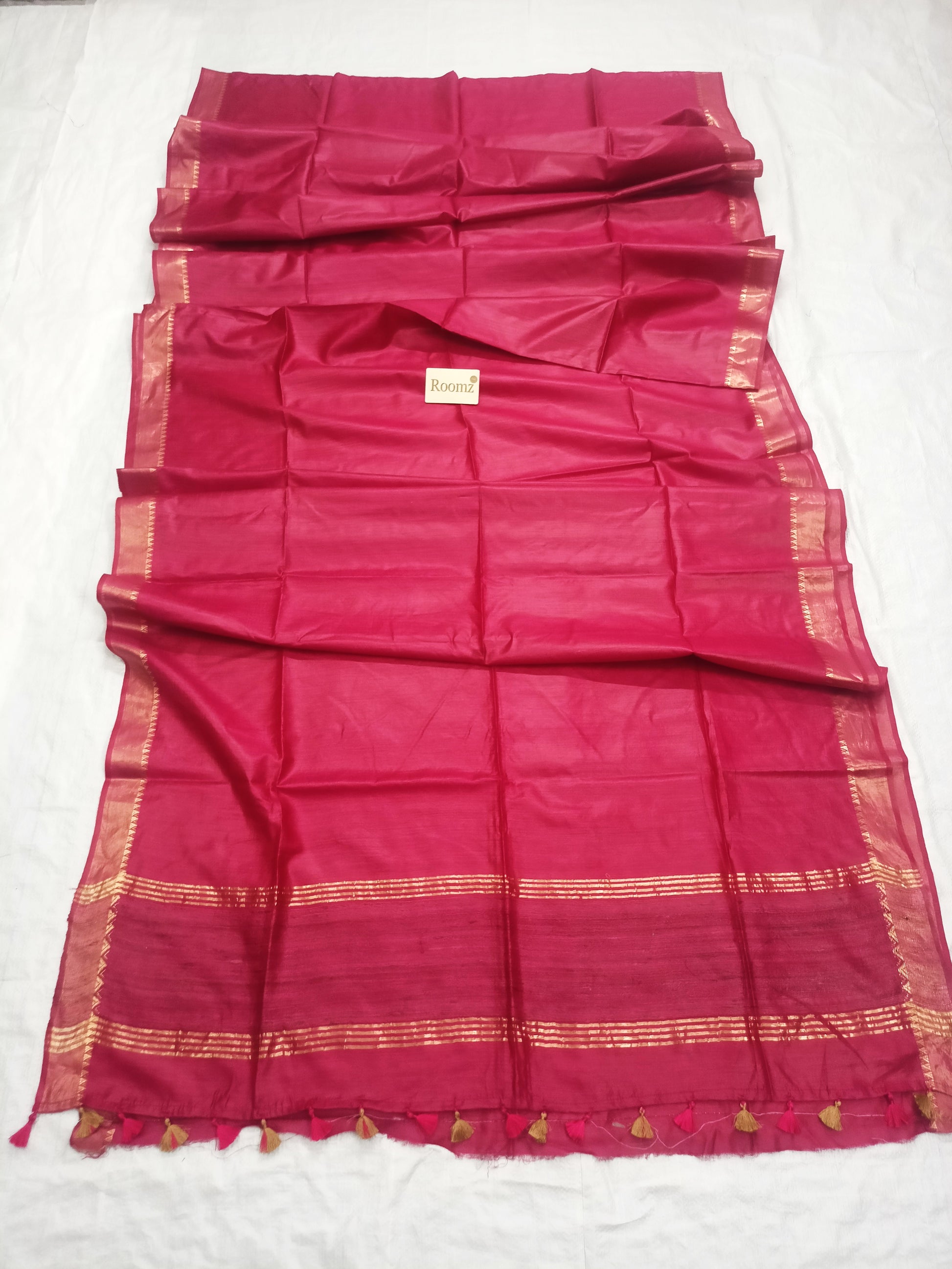 Draped red Tussar silk saree showing the golden border